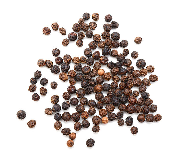 istock Black peppercorns isolated on white background. Overhead view 612753464