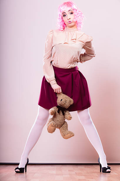 istock childlike woman with teddy bear toy 612753982