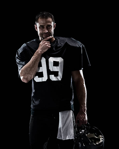 istock Smiling American football player giving a pose 612754754