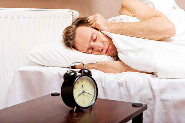 istock Man trying to sleep, when alarm clock ringing 612756342