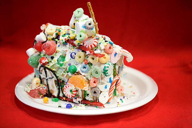Kid approved messy gingerbread house against red background stock photo