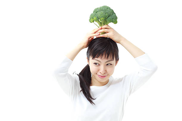 istock Japanese woman holding broccoli 612761312