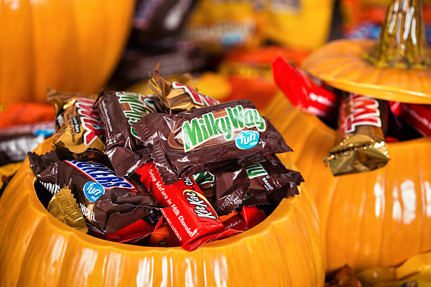 Decorative pumpkins filled with Halloween candy stock photo