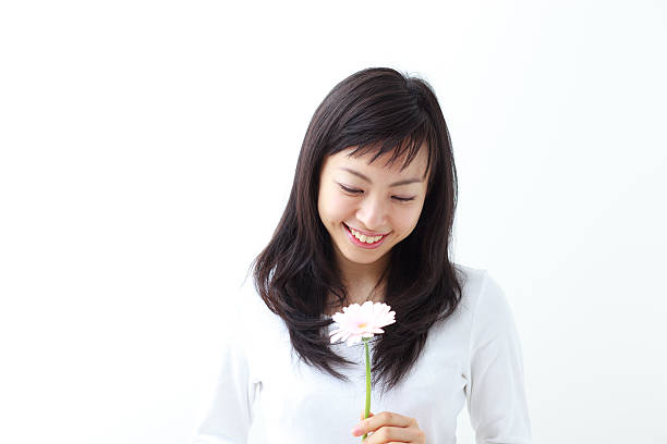 istock Japanese woman holding a flower 612816956