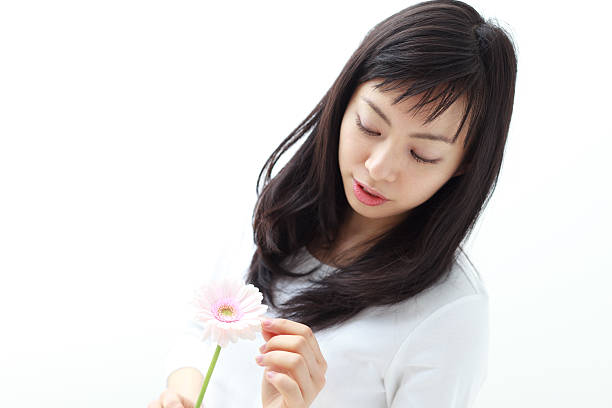 istock Japanese woman holding a flower 612816988