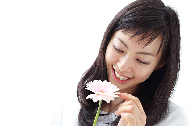istock Japanese woman holding a flower 612816992