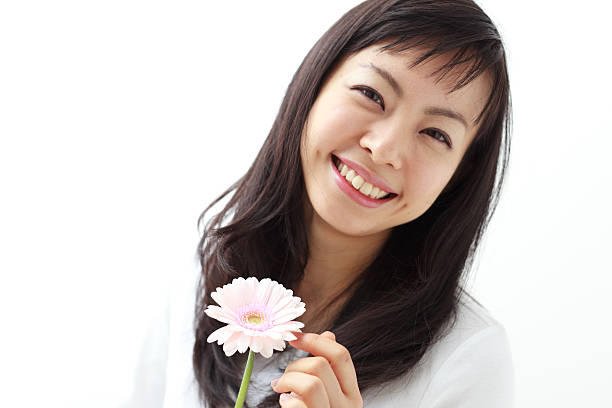 istock Japanese woman holding a flower 612817008