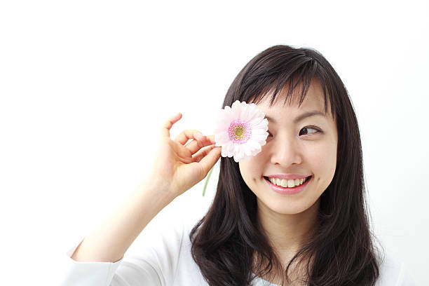 istock Japanese woman holding a flower 612817018