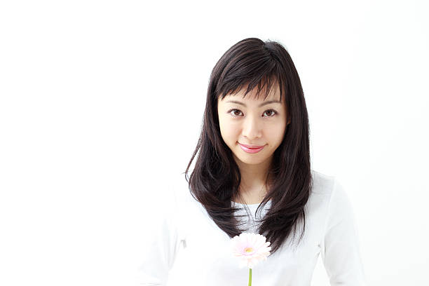 istock Japanese woman holding a flower 612817140