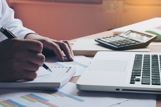 istock Businessman making notes on the paper in his office 612817930