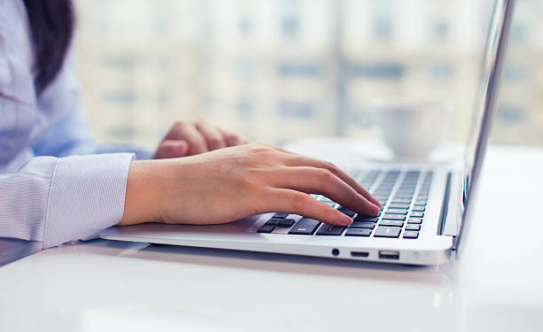 istock woman typing laptop 612818786