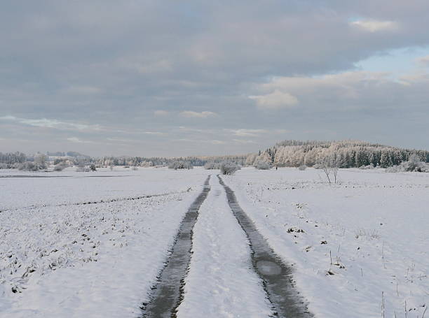 istock Car traces on winter road 612821556