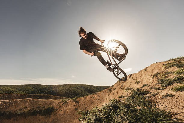 istock Young skilful cyclist in action on extreme terrain. 612823606