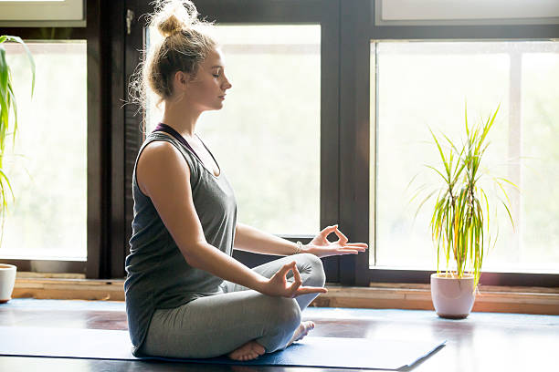 istock Yoga at home: meditating woman 612824346