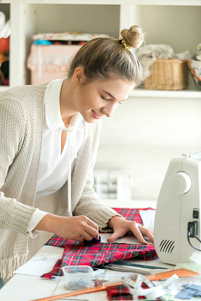 istock Portrait of a young woman working with a sewing pattern 612825758