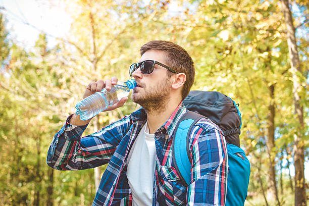 istock Handsome male traveler resting in nature 612825996