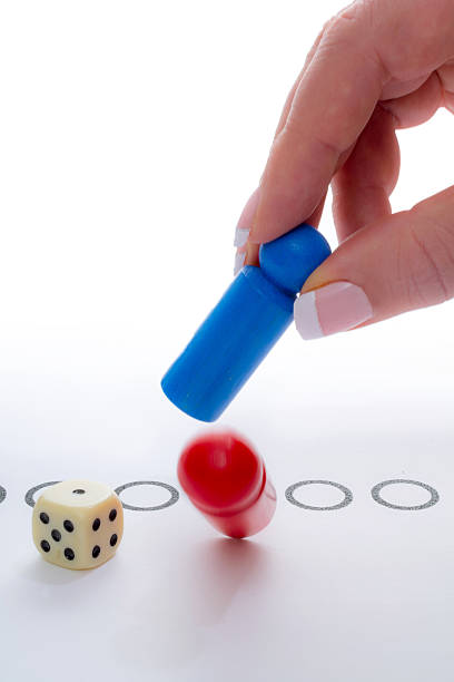 istock Woman with blue pawn takes red one 612828084