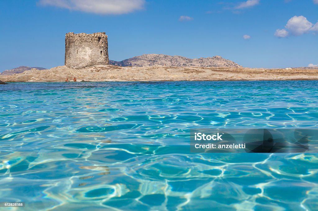 Turquoise waters at Stintino La Pelosa beach in Sardinia clear water and La Pelosa Tower in the province of Sassari, Italy Sardinia Stock Photo