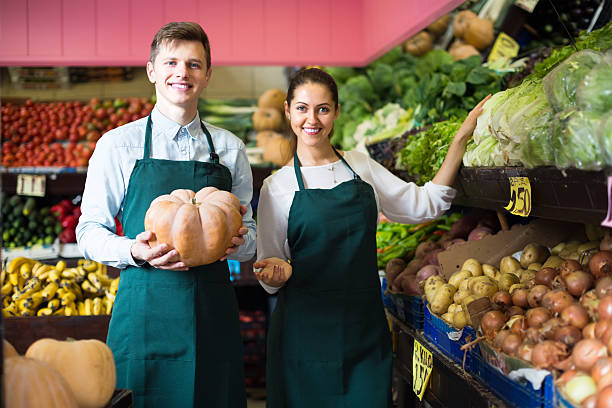 istock Sellers posing with big pumpkin 612830616