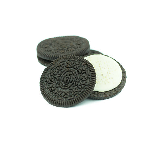 istock Chocolate cookies with creme filing isolated on white 612831664