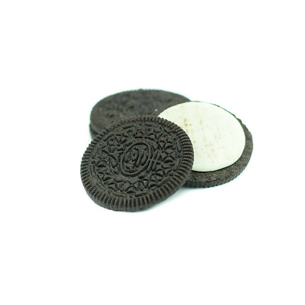 istock Chocolate cookies with creme filing isolated on white 612831690