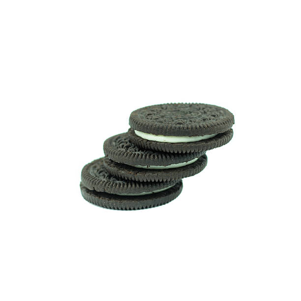 istock Chocolate cookies with creme filing isolated on white 612831760