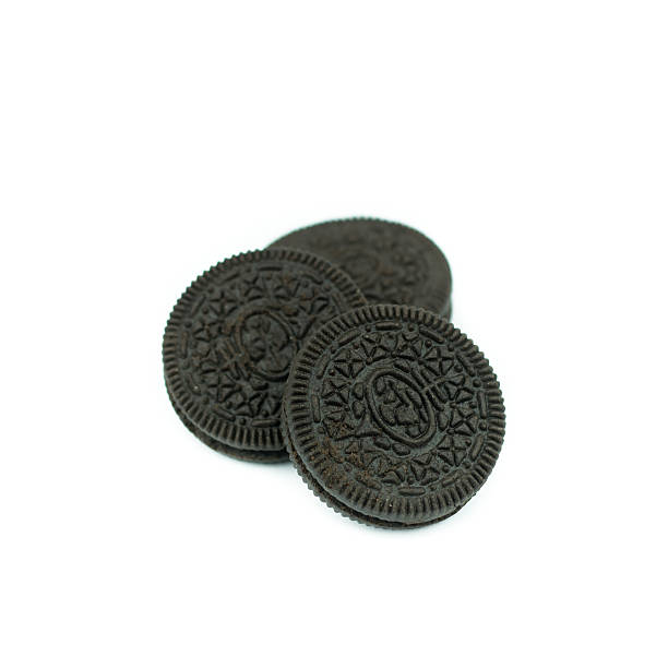 istock Chocolate cookies with creme filing isolated on white 612832874