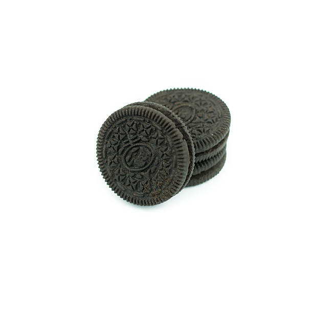 istock Chocolate cookies with creme filing isolated on white 612832898