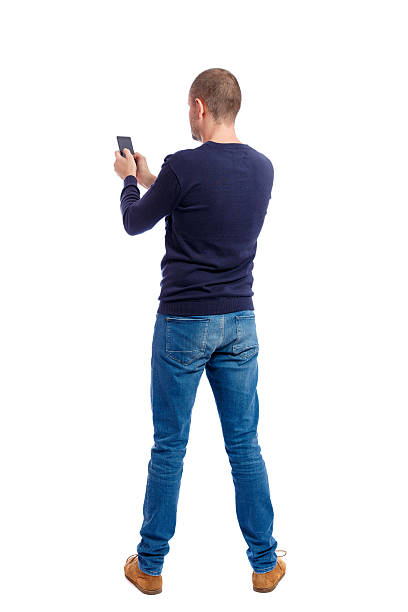 back view of man in suit  talking on mobile phone. back view of man in suit  talking on mobile phone.    rear view people collection. Isolated over white background. backside view of person. Man in black warm sweater keeps both hands free. back to front stock pictures, royalty-free photos & images