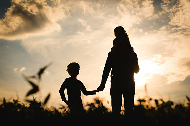 istock father with son and daughter walk at sunset 612835254