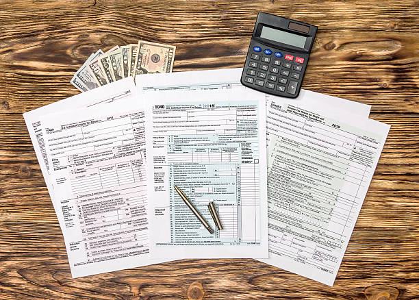 istock Tax forms with pen, money and calculator 612836540