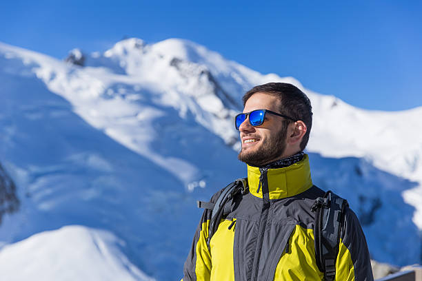 istock Hiker with beard looks at the beautiful mountains and smile 612836640