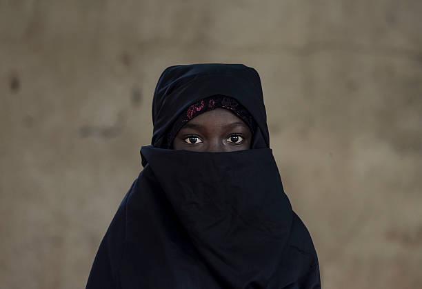 Beautiful Arab African Girl Veiled with a Niqab Bamako, Mali Little African girl posing outdoors veiled by a Niqab (typical traditional muslim clothing). arabic girl stock pictures, royalty-free photos & images