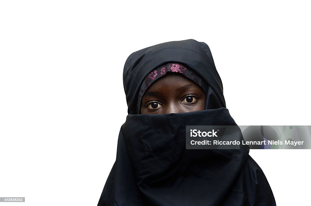 Isolated African Arab Schoolgirl Veil Niqab Little African girl posing outdoors veiled by a Niqab (typical traditional muslim clothing). Sadness Stock Photo