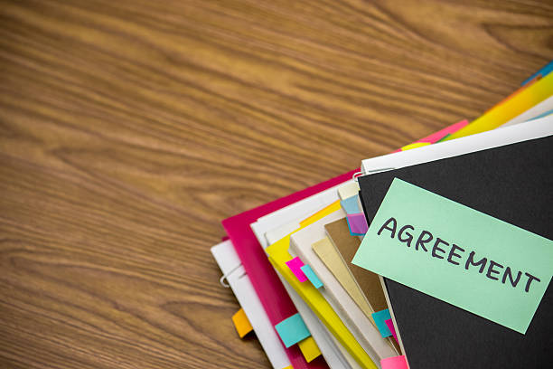 istock Agreement; The Pile of Business Documents on the Desk 612838416