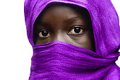 Gorgeous African Girl Hidden by Violet Head Scarf Outdoors (Isolated)