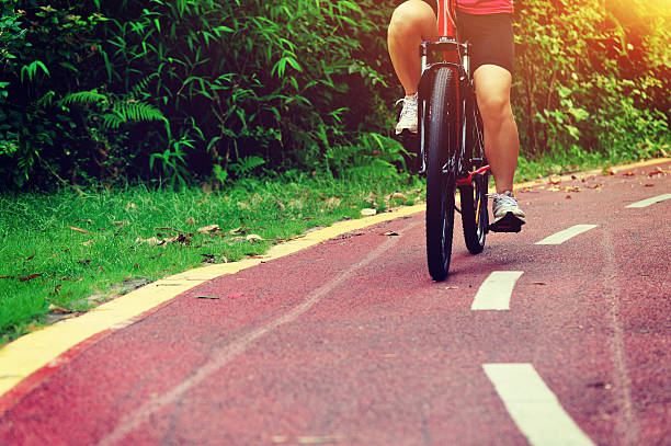 istock people legs cycling on trail at park 612840058