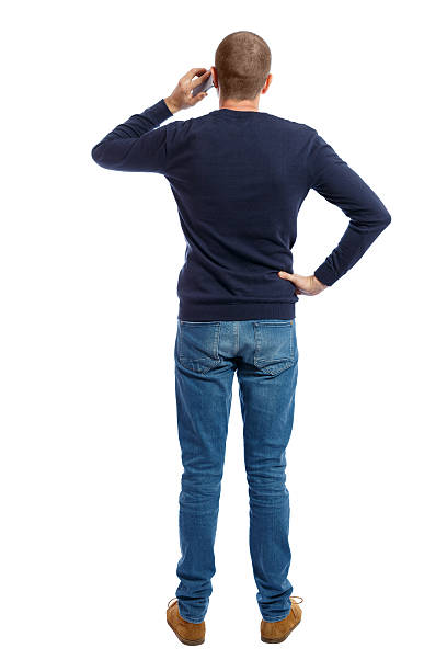 istock Back view of  pointing young men talking on cell phone. 612840100