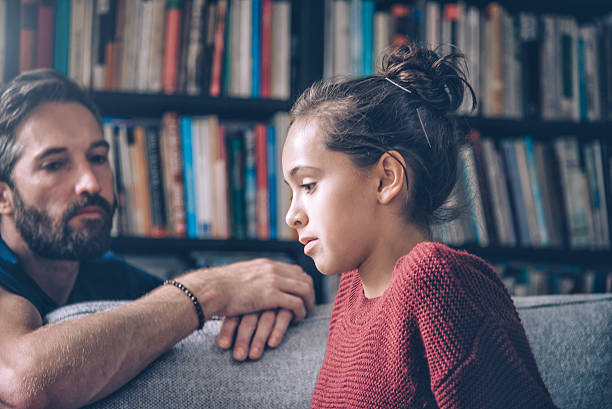 bearded father and daughter looking serious and pensive bearded father and daughter looking serious and pensive at home critical thinking kids stock pictures, royalty-free photos & images