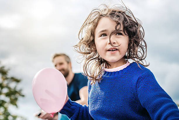 happy beautiful little girl with pink  balloon looking - family child portrait little girls imagens e fotografias de stock