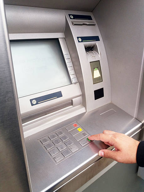 istock Close-up of hand entering PIN/pass code on ATM/bank machine keypad 612842598