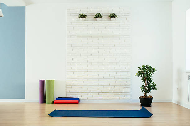 Yoga room with mat and white brick wall Yoga room with mat and white brick wall exercise room stock pictures, royalty-free photos & images