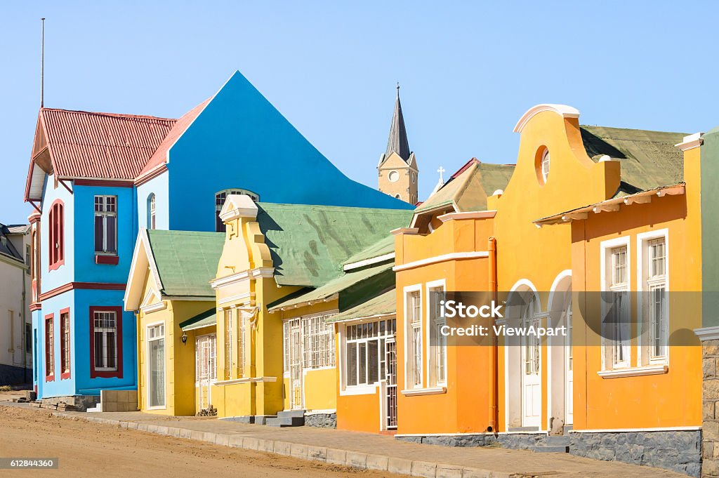 Colorful houses in Luderitz Namibia - Ancient houses german style Colorful houses in Luderitz - Architecture concept with ancient german style town in south Namibia - Exclusive travel destination in african european settlement - Warm afternoon color tones Swakopmund Stock Photo