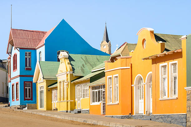 Colorful houses in Luderitz Namibia - Ancient houses german style Colorful houses in Luderitz - Architecture concept with ancient german style town in south Namibia - Exclusive travel destination in african european settlement - Warm afternoon color tones swakopmund photos stock pictures, royalty-free photos & images