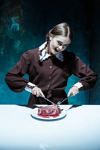 Bloody Halloween theme: crazy girl with a knife, fork and