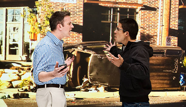 istock Men quarreling in front of car accident 612845210