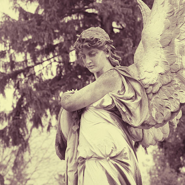 istock Vintage image of a sad angel on a cemetery 612845420