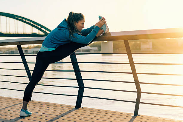 istock Female athlete stretching outdoors 612846136
