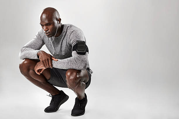 istock African male model crouching on grey background 612847944