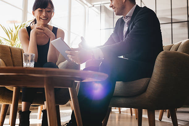 istock Corporate colleagues discussing business ideas on digital tablet 612849038
